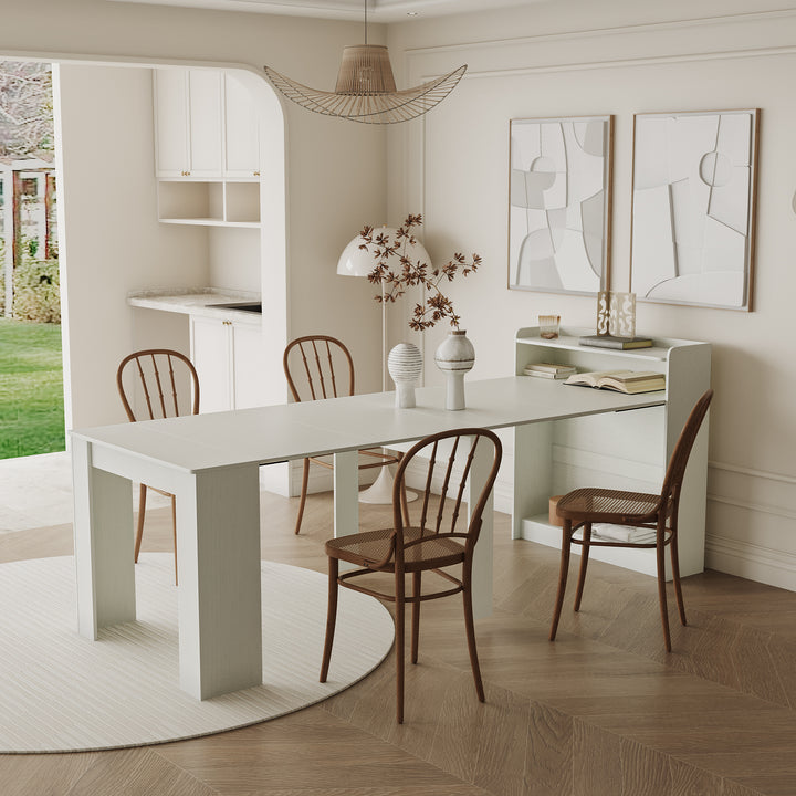 Modern dining area with a white table and wooden chairs in a bright room.