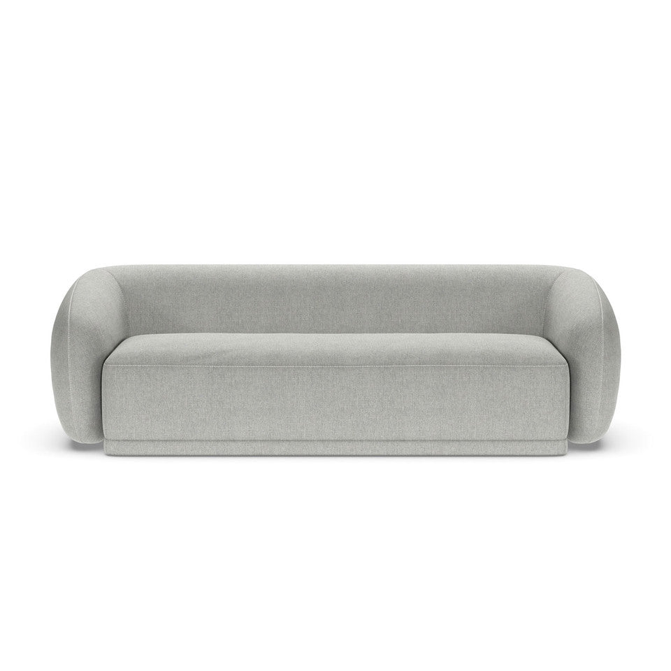 A beige Athlea sofa with a modern design, featuring a streamlined shape and minimal backrest, made from high-density foam.