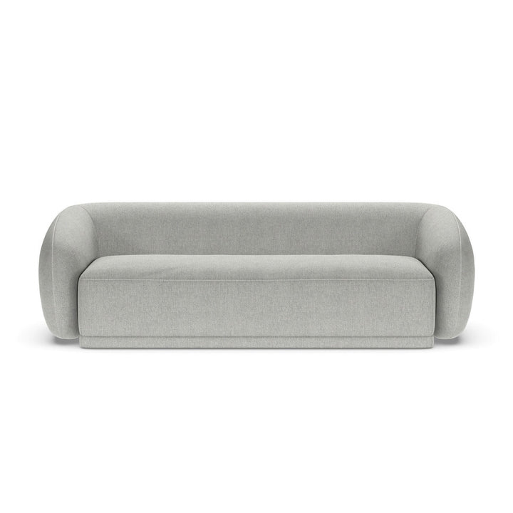 A beige Athlea sofa with a modern design, featuring a streamlined shape and minimal backrest, made from high-density foam.
