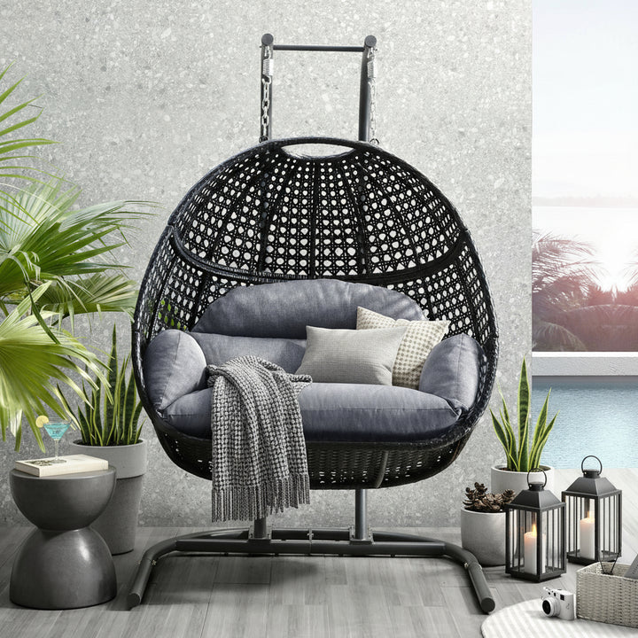 Hanging double-seat swing chair with black wicker and gray cushions