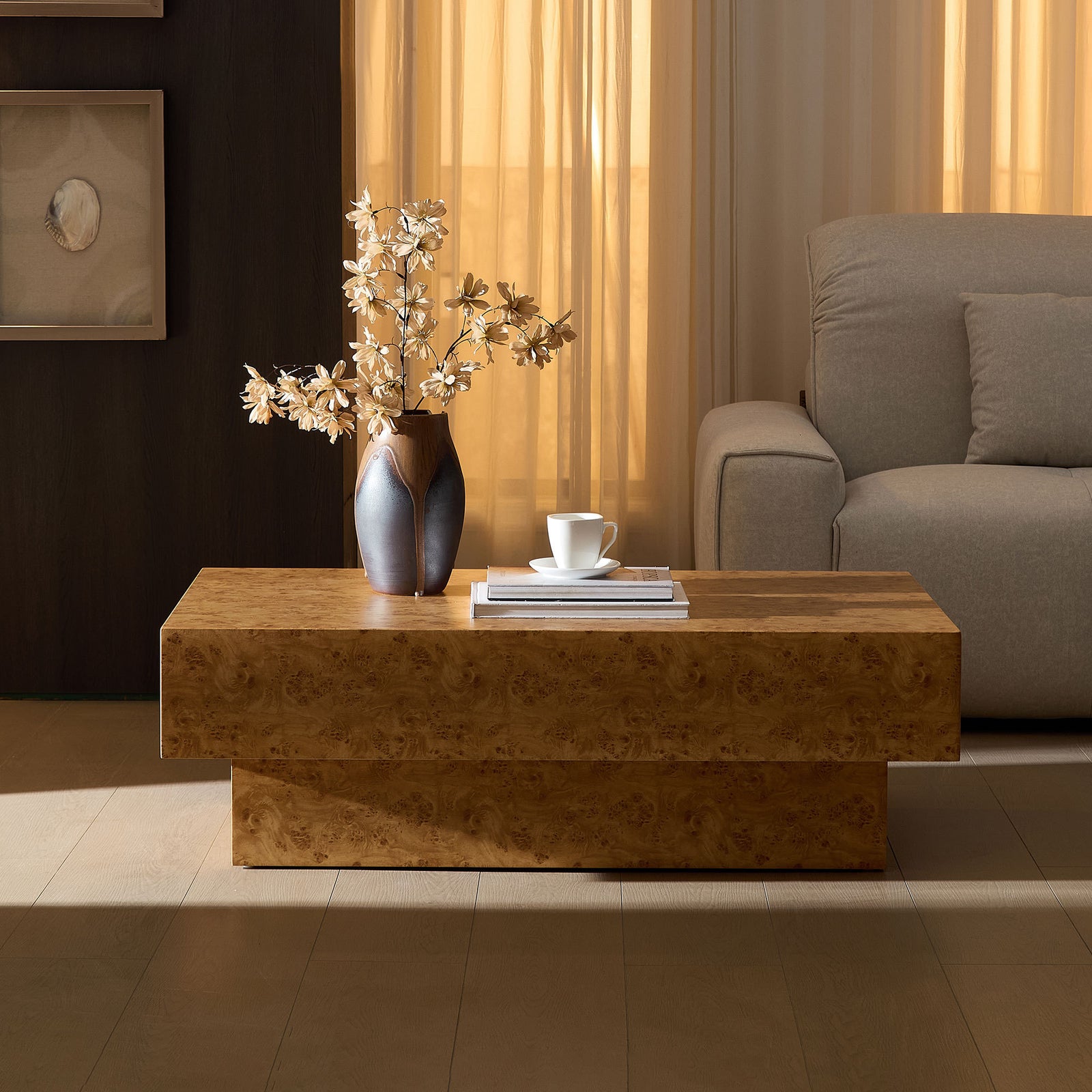 Modern faux burl wood pedestal coffee table in living room.