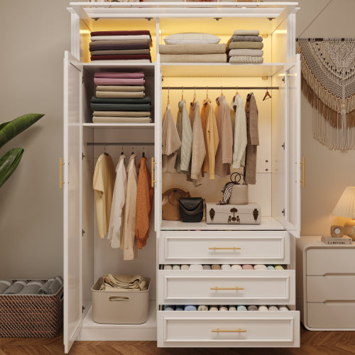 White wardrobe with clothes and drawers in a room setting
