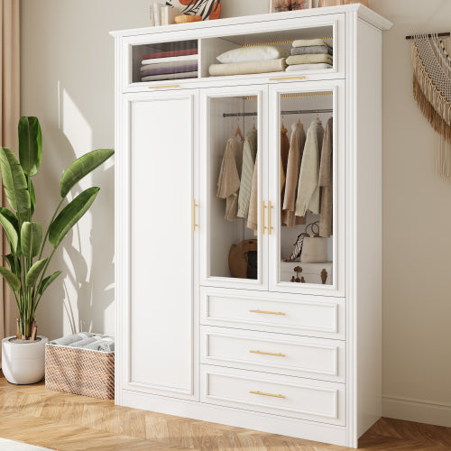 White wardrobe with glass doors displaying clothes, placed in a room with a plant and basket.