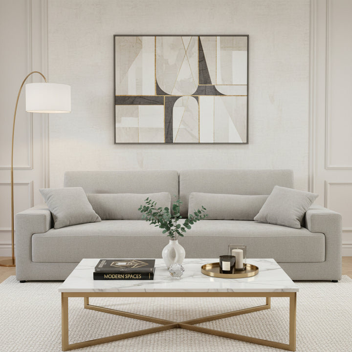 Beige sofa with cushions on a white background