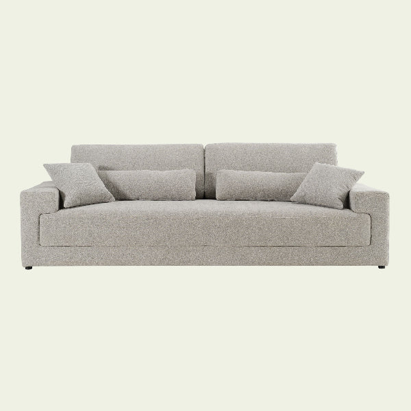 Beige sofa with cushions on a white background