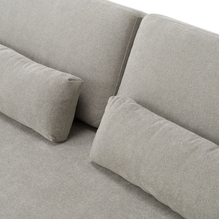 Gray fabric sofa with cushions on a light gray background