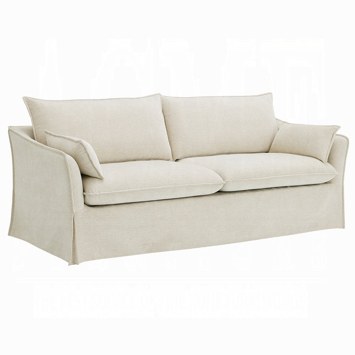 Beige sofa with cushions on a white background