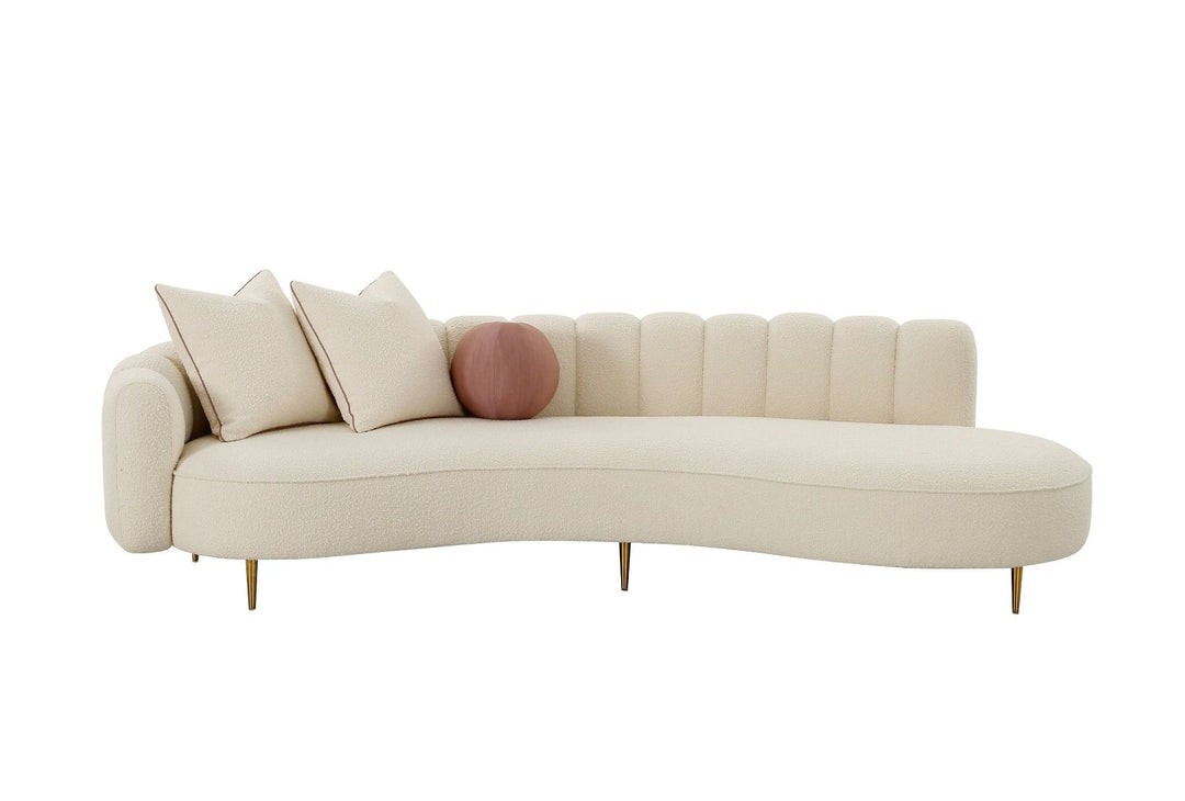 Beige curved sofa with decorative pillows on a white background