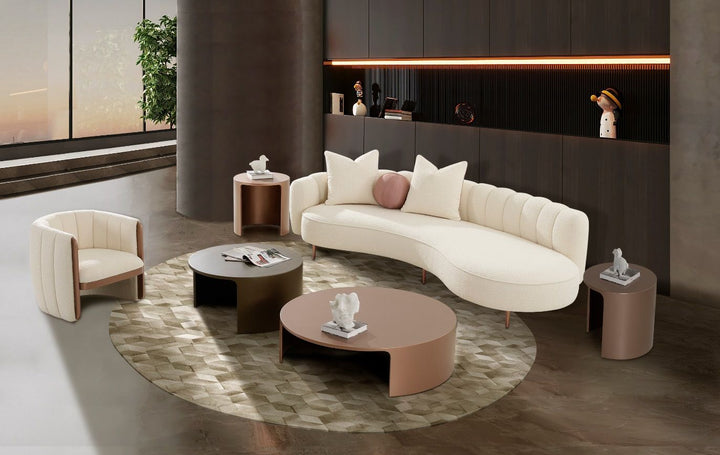 Modern living room with a curved white sofa, round coffee table, and decorative items.